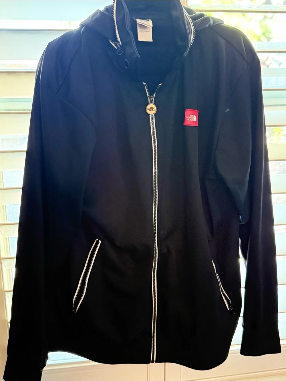 The North Face Black Jacket with Red Logo Patch